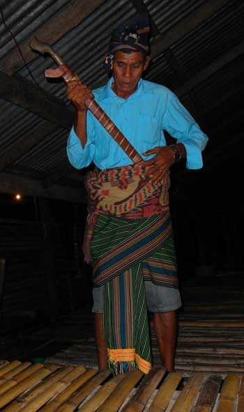 Getting dressed with sword for a traditional ceremony in Sumba, Indonesia