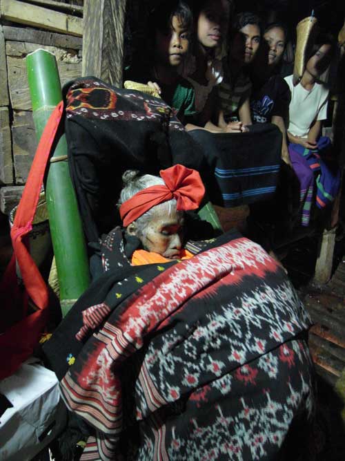 A dead grandmother receives guests before her funeral in Sumba, Indonesia