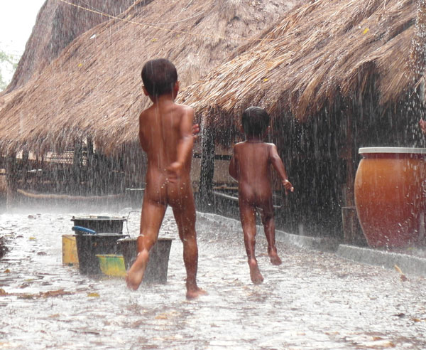 Kids in Tarong village, West Sumba, play in the rain