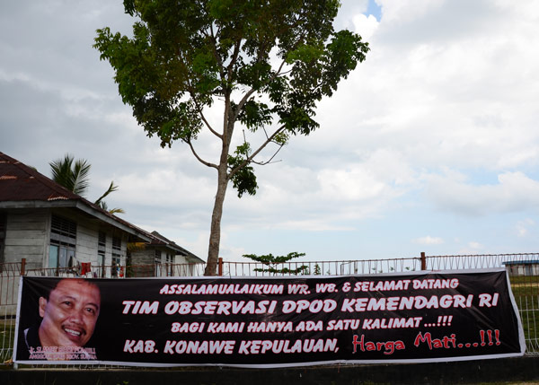 A banner demands a new Indonesian district, "At All Costs"